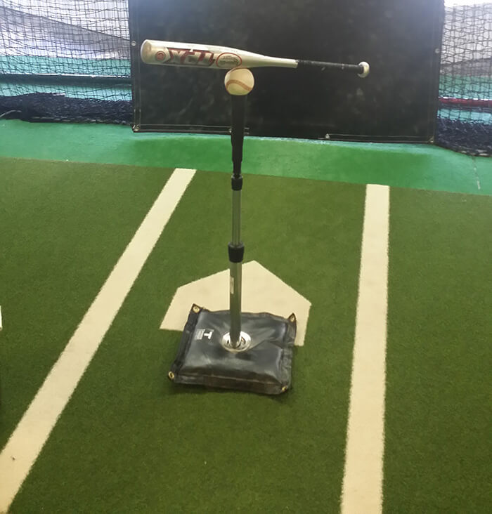 bat and baseball balancing on a tee